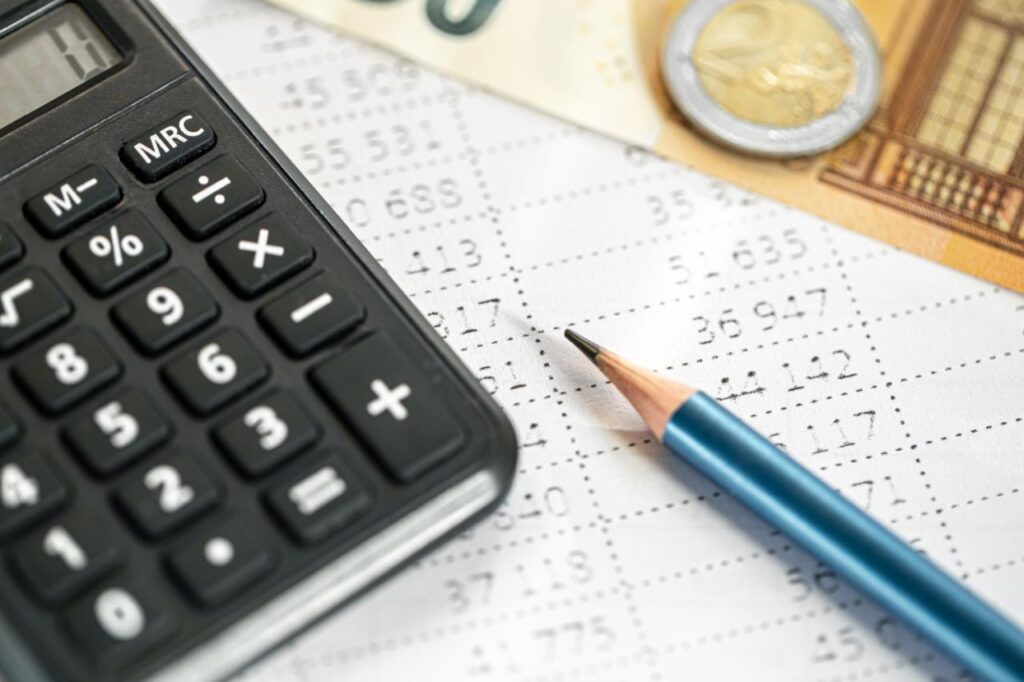 calculator money pencil closeup blurred background